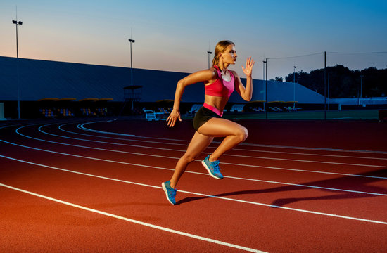 Runner sprinting towards success on run path running athletic track. Goal achievement concept.