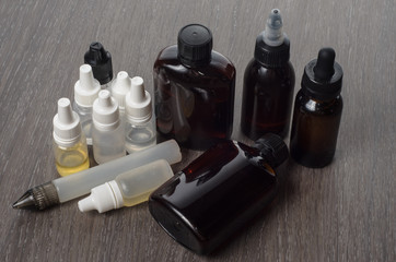 vaping e-cigarette liquid on wooden background