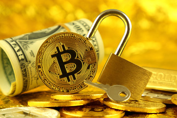 Physical version of Bitcoin (new virtual money) and golden padlock. Conceptual image for money and...