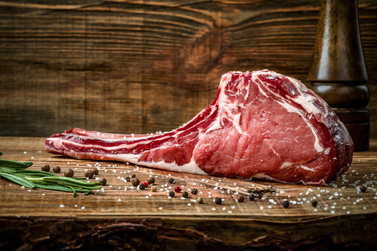 Dry Aged Raw Tomahawk Beef Steak With Ingredients For Grilling