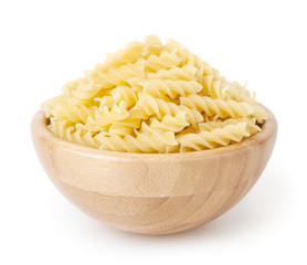 Uncooked fusilli pasta in wooden bowl isolated on white background with clipping path