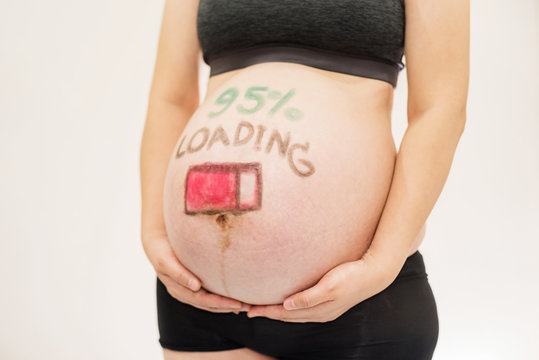 Pregnant with loading concept painted on belly
