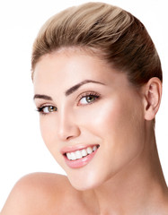 Beautiful face of young adult woman with clean fresh skin. Amazing smile, perfect teeth.