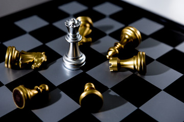 Investment Leadership Concept : The king chess piece with chess others nearby go down from floating board game concept of business ideas and competition and strategy plan success meaning,