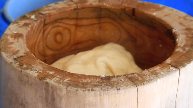 Cooking mochi - glutinous cakes of pounded rice.