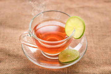 glass of hot tea with lamondon hemp sack and table in morning.