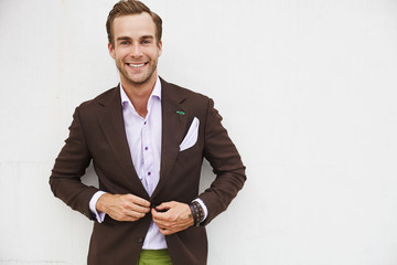 Portrait caucasian hipster stunna guy in stylish suit with brown top