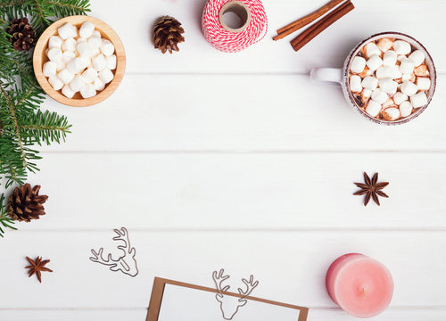 Hot chocolate and other Christmas accessories on the white table