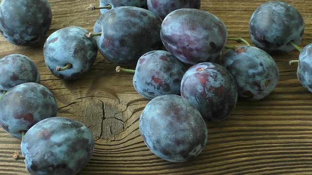 Fresh plums on wooden table
