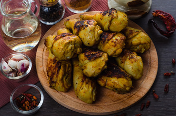 grilled chicken legs on wooden background