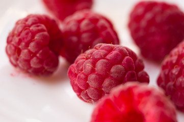 raspberries on a white saucer close up