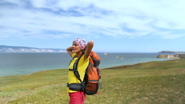 Woman hiker walking. Hiking girl walking alone in beautiful landscape nature. Caucasian girl living healthy lifestyle. Olkhon island, Lake Baikal, Russia
