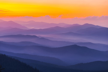 Fototapeta na wymiar mountain valley in a blue mist at the dusk