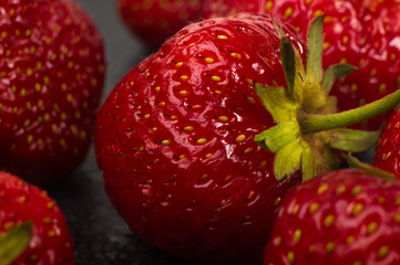 fresh ripe strawberries on black ceramic plate