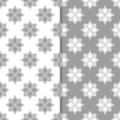 White and gray floral backgrounds. Set of seamless patterns