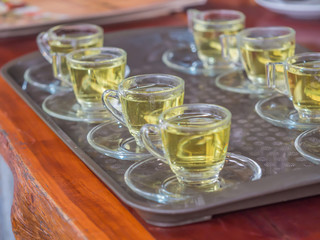 Preparing glasses of tea for serving customer.