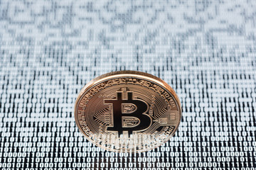 Bitcoin shallow depth of field on white binary code background
