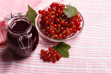 fresh red currant and jam on the rustic background