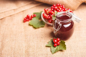 fresh red currant and jam on the rustic background