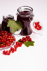 fresh red currants and jam on a white background