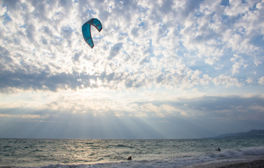 kitesurfer rides a kite-surf on waves of the sea