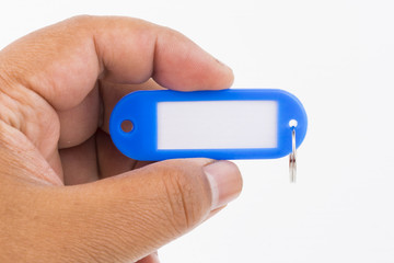 Concept hand hold keychain marker on isolated white background with copy space for word