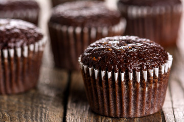 Chocolate muffins on wooden table