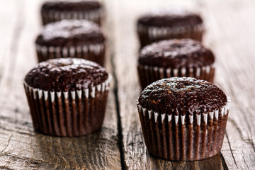 Chocolate muffins on wooden table