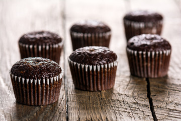 Chocolate muffins on wooden table