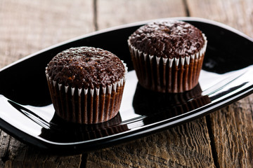 Chocolate muffins on wooden table