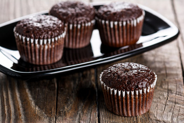 Chocolate muffins on wooden table