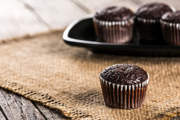 Chocolate muffins on wooden table