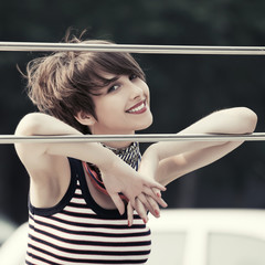 Happy young fashion woman in tank top and silk scarf outdoor