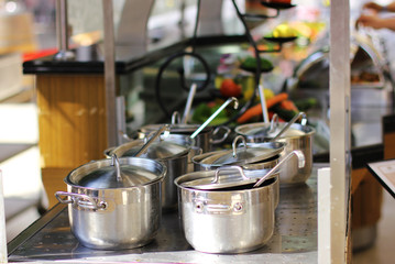 Six saucepans of stainless steel on the stove