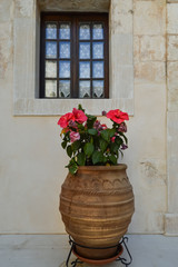 Fototapeta na wymiar Big amphora and small vase with flowers