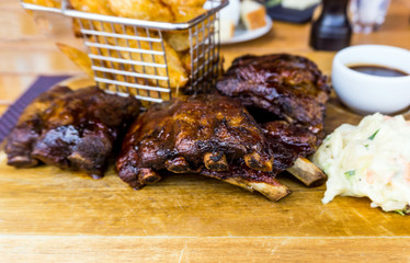 Grilled steak - Grilled meat ribs on the plate with hot sauce