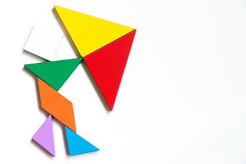 Color wood tangram puzzle on human hold the umbrella shape on white background (Concept for business face the crisis)