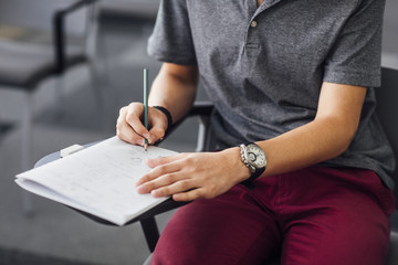 Male Student Taking Notes