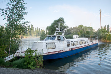 Fototapeta na wymiar white boat on the lake near the nuclear power plant