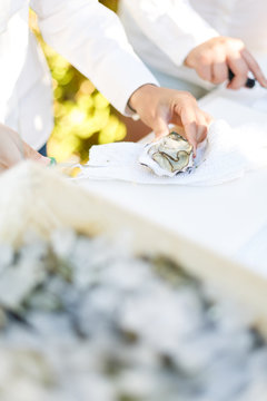 Waiter opening an oyster