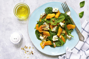 Pumpkin salad with spinach,blue cheese and nuts.Top view.