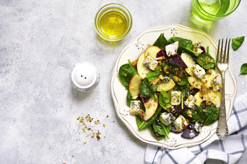 Autumn beet root salad with blue cheese,apple,,spinach and walnut.Top view.