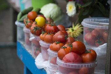 tomatoes on the market in a plastic bucket