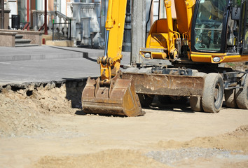 Excavating machine on road site