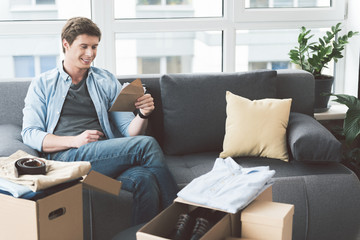 Fototapeta premium Smiling male looking at envelope