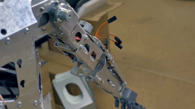 A robots arm with sticking out cables.