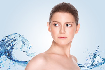 Beautiful girl with clean skin on a background of splashing water