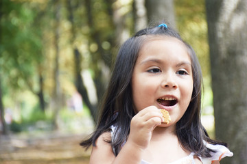 Latin kid eating cookie