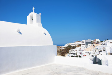 Santorini Island, Greece, Europe. Traditional white Greek architecture over Caldera, a beautiful landscape with a blue sky and famous white houses and churches.