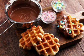 Belgium waffles with chocolate sauce. popsicles with chocolate and wafer.